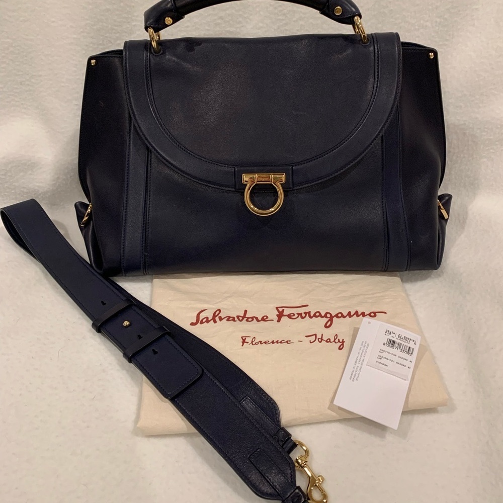 This classic navy leather handbag is a timeless piece. It was barely worn.